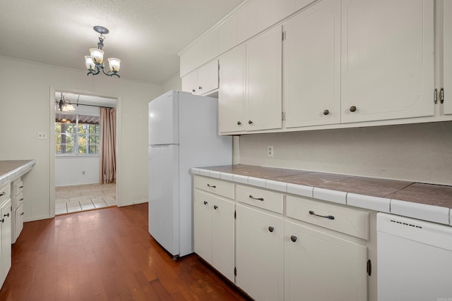 kitchen with tile counters, dark hardwood / wood-style flooring, and white cabinets