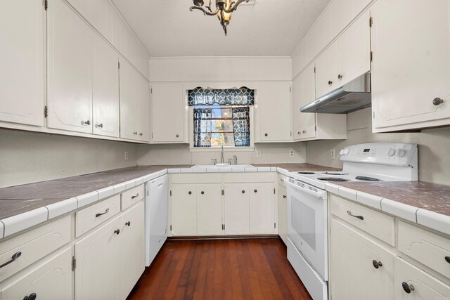 kitchen featuring tile countertops, white cabinets, and white appliances