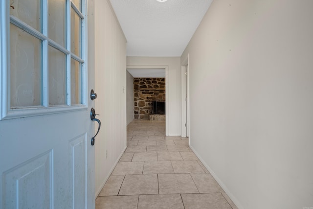 interior space featuring light tile patterned floors and a textured ceiling