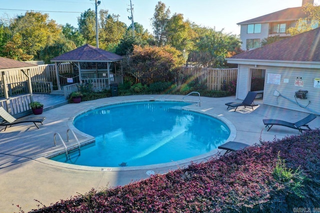 view of swimming pool featuring a gazebo and a patio area