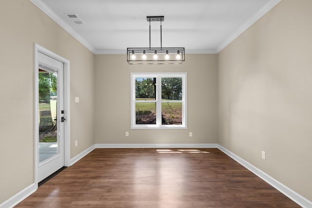 unfurnished dining area featuring ornamental molding, dark hardwood / wood-style flooring, and a healthy amount of sunlight