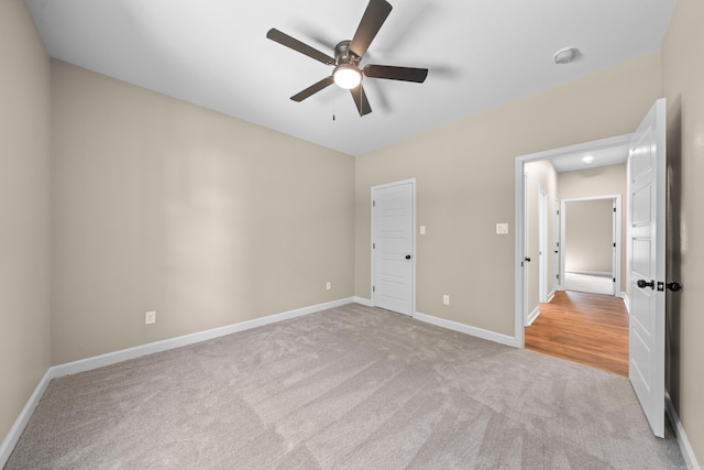 unfurnished bedroom with ceiling fan and light carpet