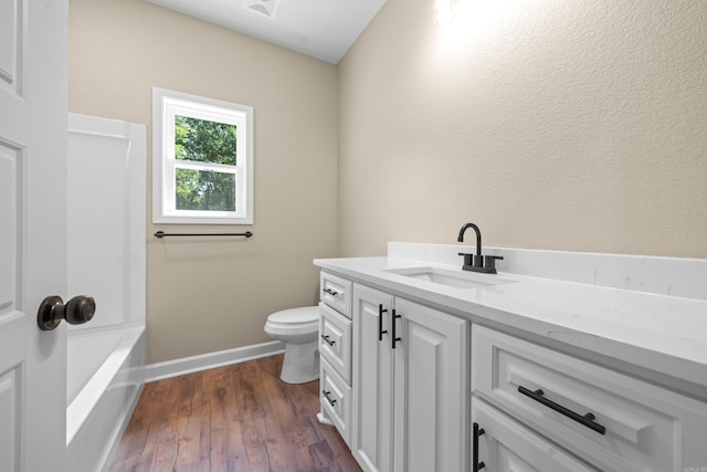 bathroom with hardwood / wood-style floors, vanity, and toilet