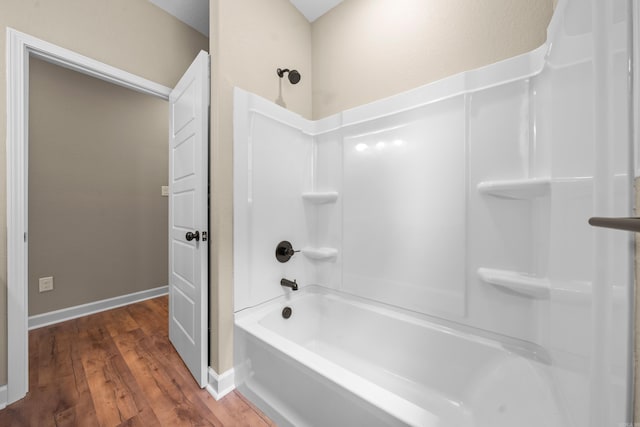 bathroom with hardwood / wood-style floors and shower / bathtub combination