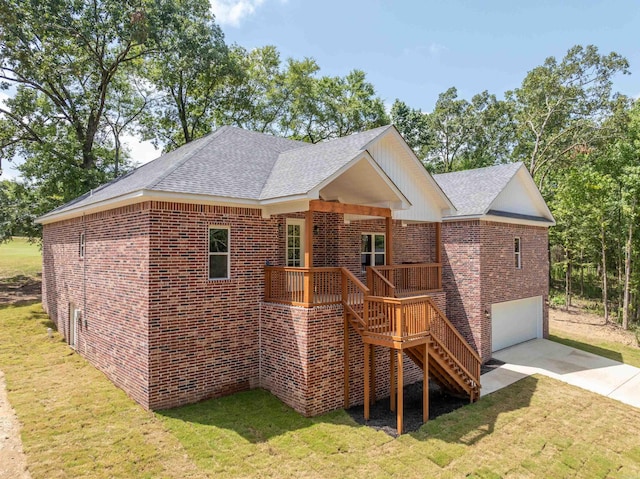 back of house featuring a lawn and a garage