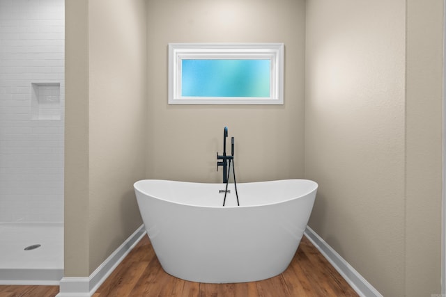 bathroom featuring hardwood / wood-style floors and independent shower and bath