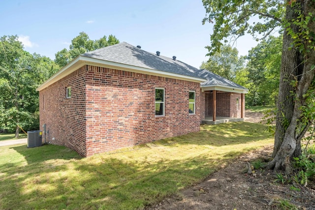 view of home's exterior featuring central AC and a lawn