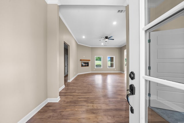 entryway with wood-type flooring, ceiling fan, and ornamental molding