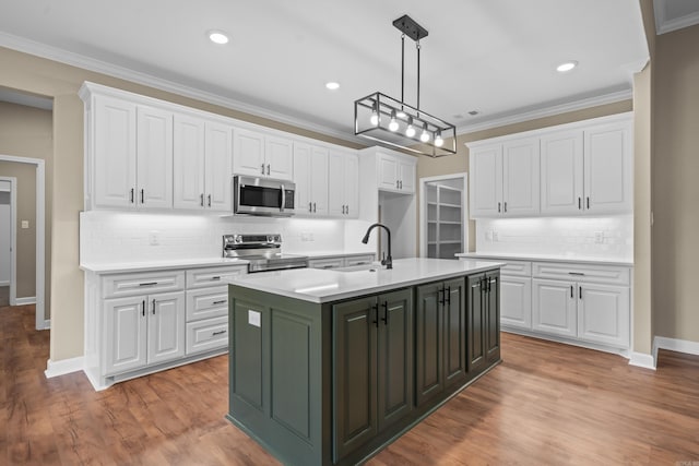 kitchen featuring stainless steel appliances, white cabinetry, and a center island with sink