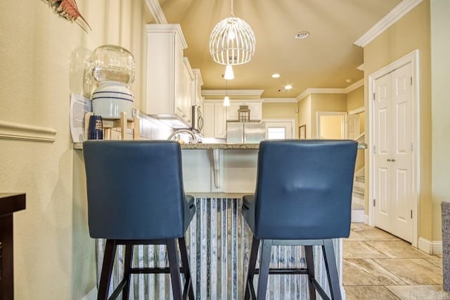 dining space with crown molding and a chandelier