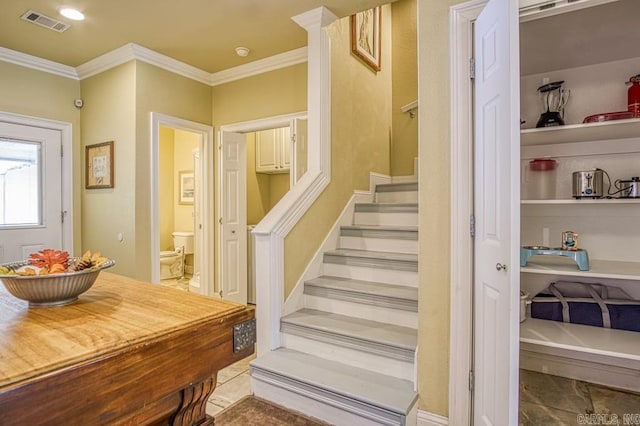 staircase featuring ornamental molding