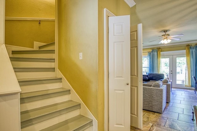 stairs featuring ceiling fan, crown molding, and french doors