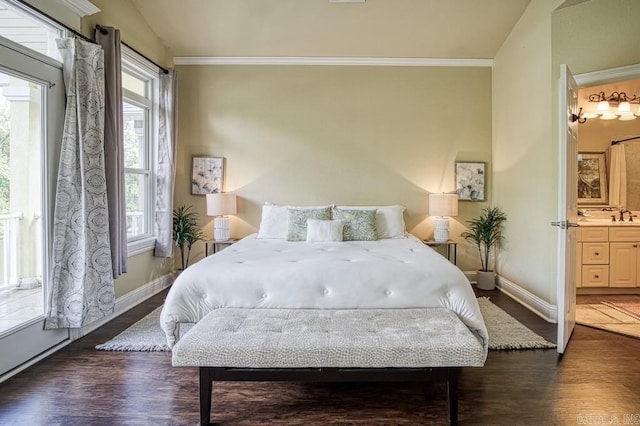 bedroom with vaulted ceiling, dark hardwood / wood-style flooring, ornamental molding, and ensuite bath