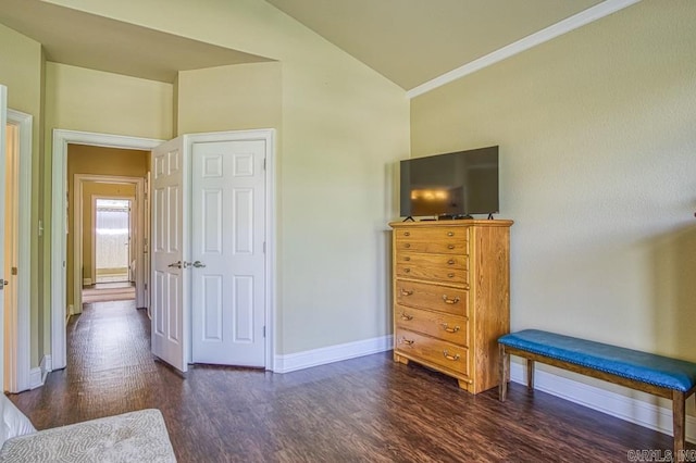 bedroom featuring dark hardwood / wood-style floors, lofted ceiling, and ornamental molding