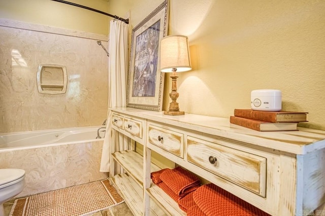 bathroom with tile patterned flooring, shower / tub combo with curtain, and toilet