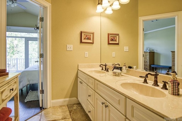 bathroom with vanity, ceiling fan, and vaulted ceiling