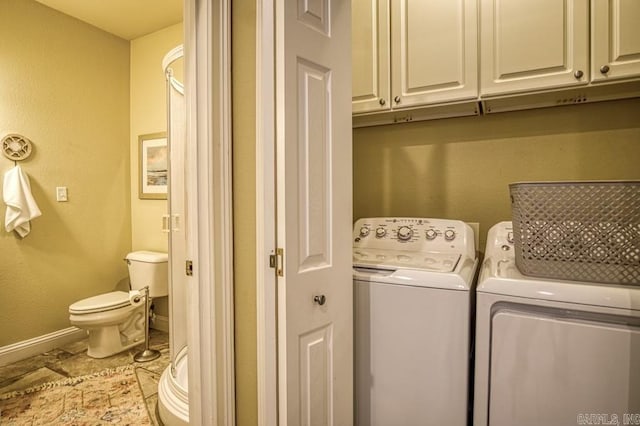 washroom with washer and dryer, light tile patterned flooring, and cabinets