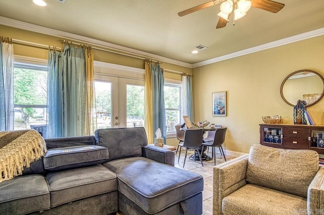 living room featuring a wealth of natural light, french doors, ceiling fan, and crown molding