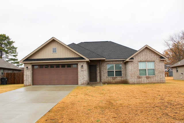 view of front of home with a front yard and a garage