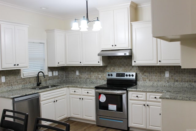 kitchen featuring appliances with stainless steel finishes, tasteful backsplash, decorative light fixtures, white cabinets, and sink