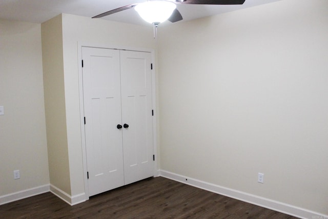 unfurnished bedroom featuring ceiling fan, dark hardwood / wood-style floors, and a closet