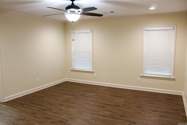 empty room with dark wood-type flooring, ornamental molding, and ceiling fan