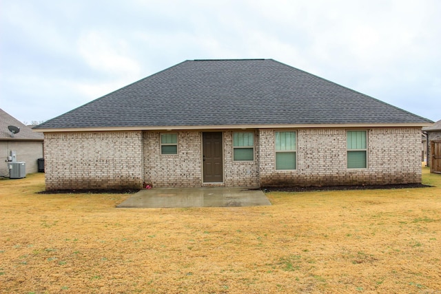 rear view of house with a patio area, central air condition unit, and a lawn