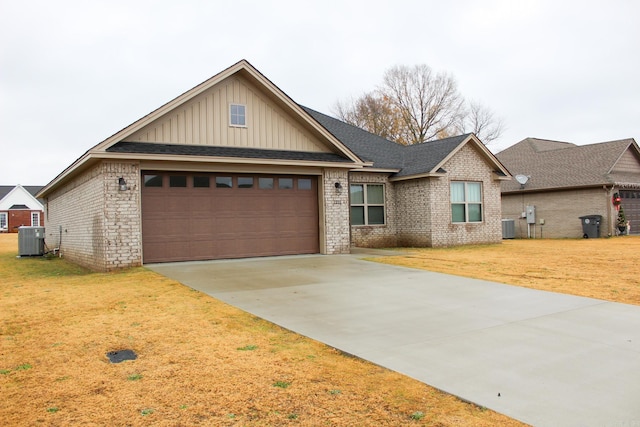 view of front of property featuring central air condition unit, a garage, and a front yard