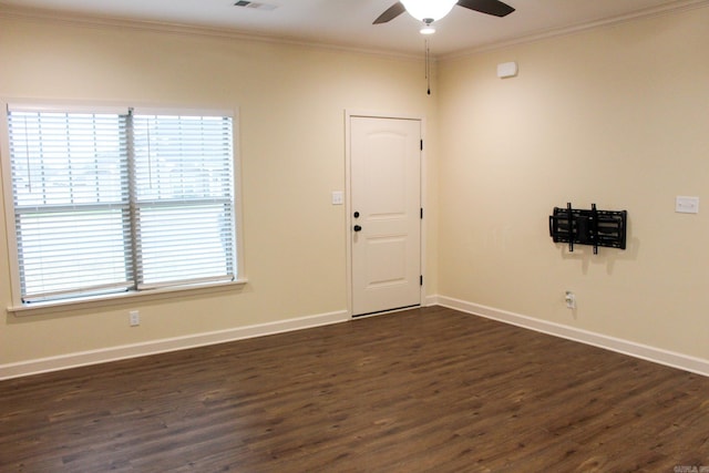 spare room featuring ceiling fan, dark wood-type flooring, and ornamental molding