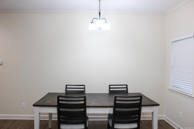 dining room with dark hardwood / wood-style flooring, crown molding, and a notable chandelier