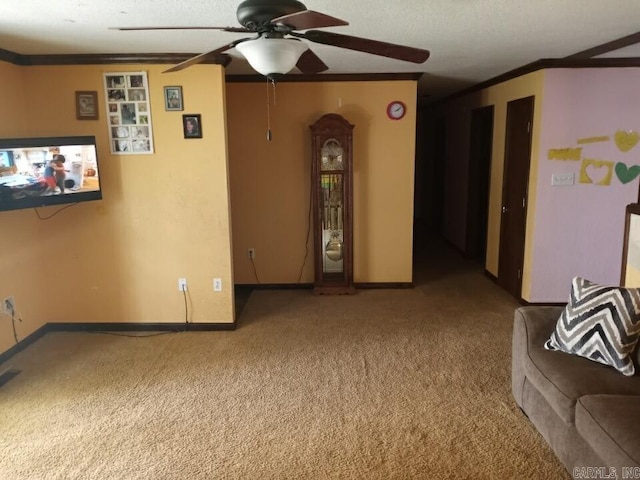 carpeted living room featuring ceiling fan, a textured ceiling, and ornamental molding