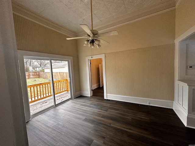 empty room with dark hardwood / wood-style floors, ceiling fan, and ornamental molding