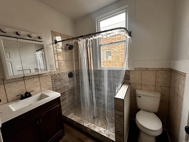 bathroom with vanity, curtained shower, toilet, and tile walls