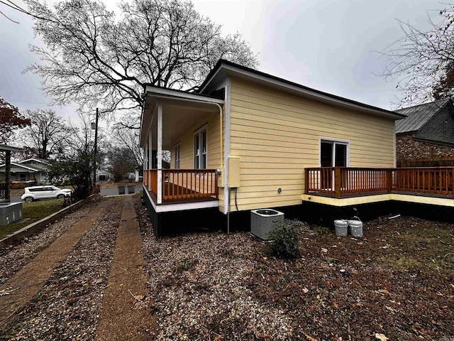 view of property exterior with central air condition unit and a deck