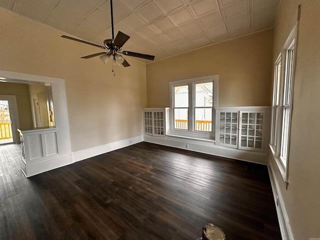 empty room featuring ceiling fan and dark wood-type flooring