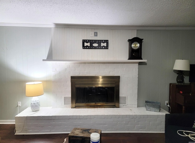 details with wooden walls, a fireplace, a textured ceiling, and hardwood / wood-style flooring