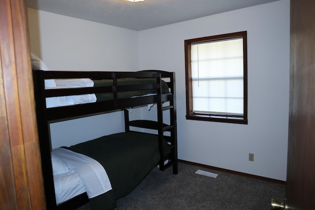 bedroom featuring dark colored carpet