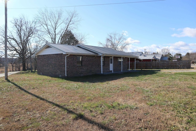 rear view of house with a yard