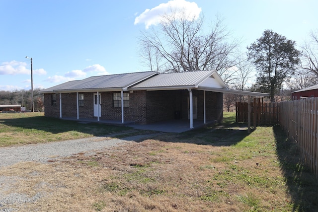 exterior space featuring a carport and a front lawn