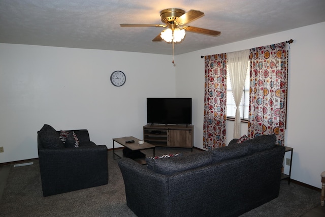 carpeted living room featuring ceiling fan and a textured ceiling