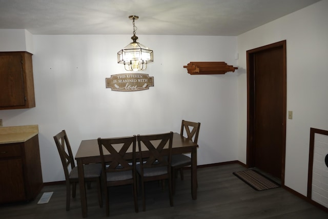 dining room with a chandelier and dark hardwood / wood-style flooring