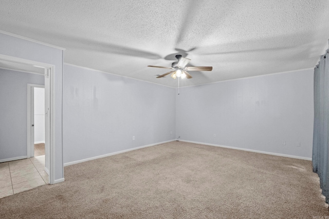 spare room featuring light colored carpet and a textured ceiling