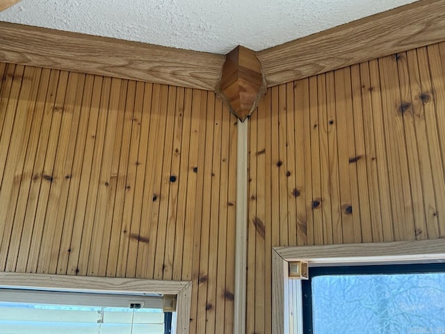 details with a textured ceiling and wooden walls