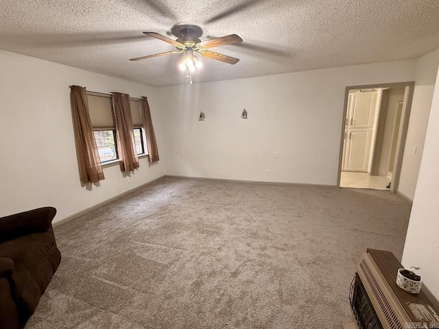 interior space with carpet flooring, ceiling fan, and a textured ceiling