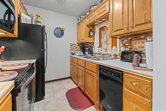 kitchen featuring black appliances, sink, decorative backsplash, a textured ceiling, and light tile patterned flooring