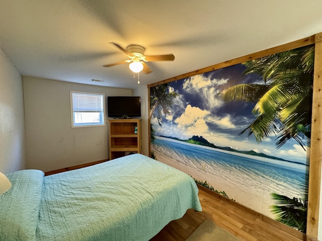 bedroom featuring ceiling fan and hardwood / wood-style floors