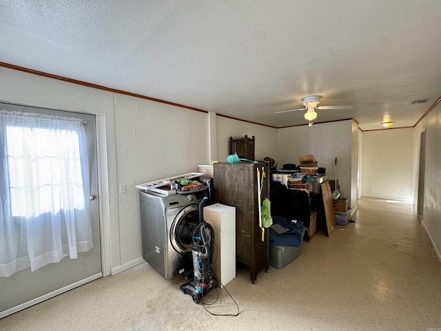 laundry area with ceiling fan, washer / dryer, ornamental molding, and a textured ceiling