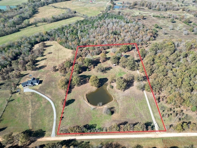 drone / aerial view featuring a rural view and a water view