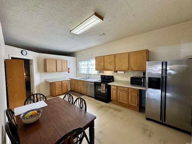 kitchen featuring black appliances, sink, and a textured ceiling