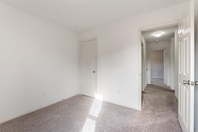 spare room featuring light colored carpet